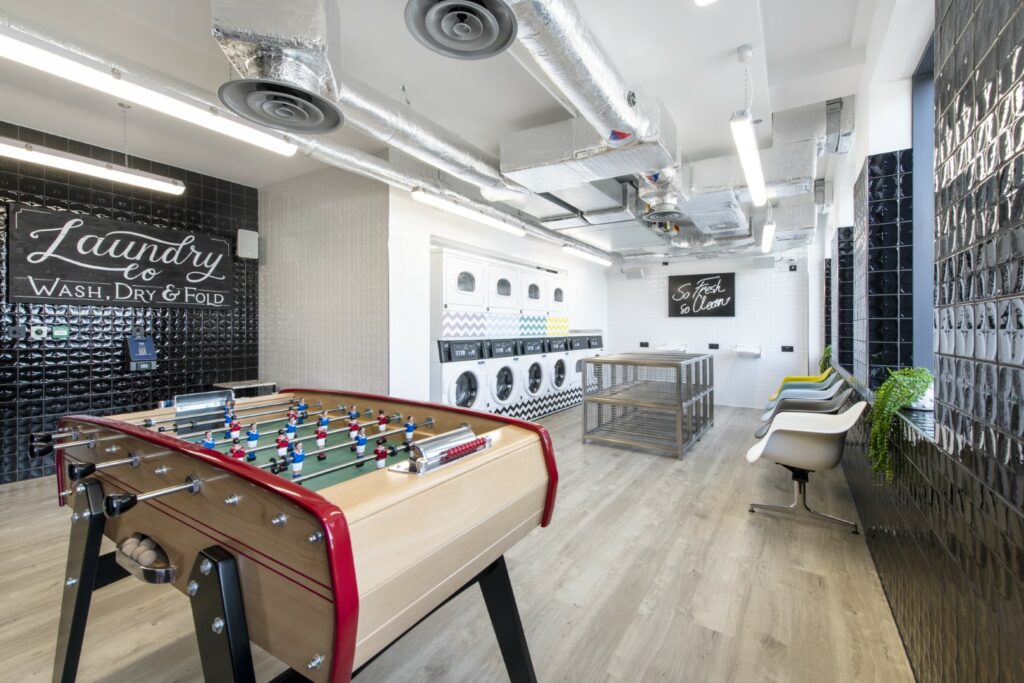 Inside laundry & games room - shows a table football table and washing machines and chairs